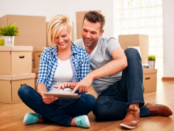 a happy couple looking at a real estate listing