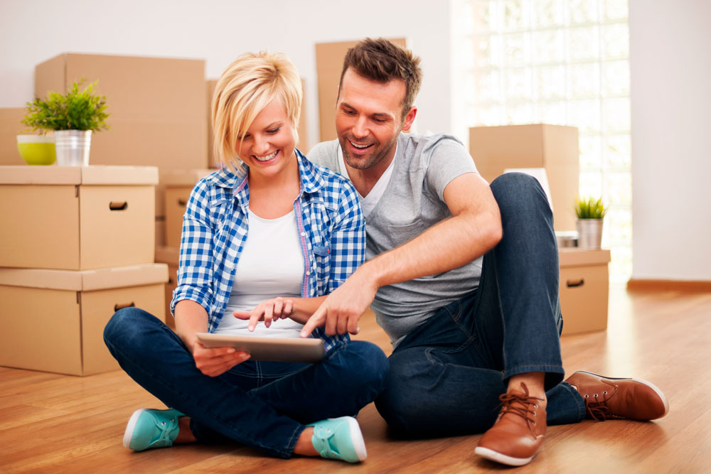 a happy couple looking at a real estate listing