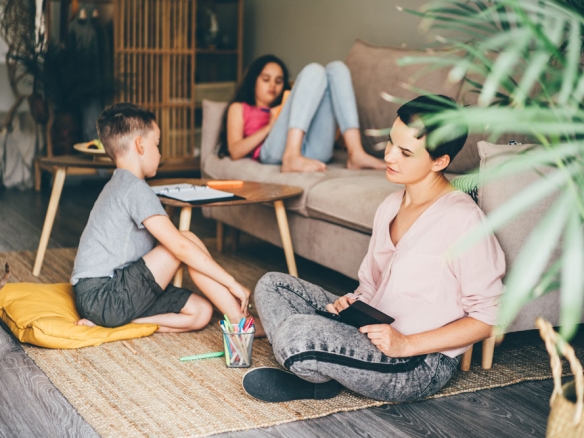 a family of three sitting in the living room
