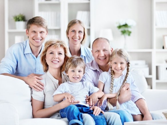 An image of a happy family of six in their new home